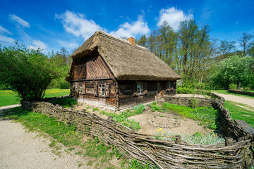 Fototapeta na wymiar Stara drewniana chatka na wsi w otoczeniu naturalnej przyrody