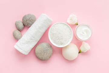Layout of white cosmetics products and roses flowers, top view
