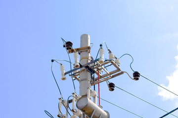 High Electric voltage wires and pole power lines,electric towers,power transformer against vibrant...