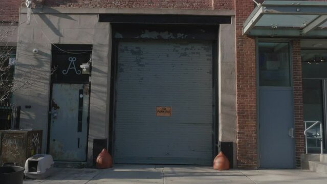 Handheld shot of a garage with a no parking sign in Brooklyn
