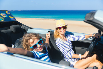 Happy family travels by car on summer vacation