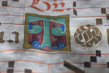 Detail with initial letter from illuminated antiphonary manuscrip - obrazy, fototapety, plakaty