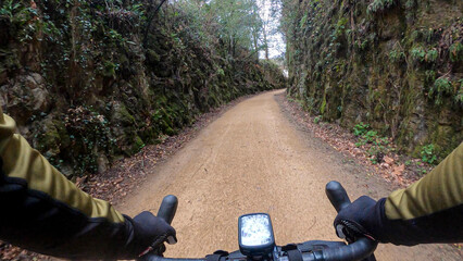Rider point of view of a gravel bike riding on sandy rural countryside path