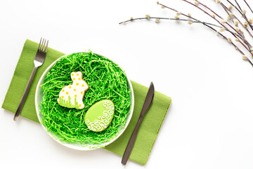 Festive table setting for Easter dinner with a spring willow sprig - 785718597