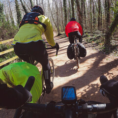 Riding a gravel bike on a group ride with ruck sack and back packing travelling cycling point of view