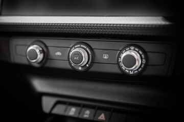 Car air conditioning system buttons, dials closeup. Warm and cool settings.