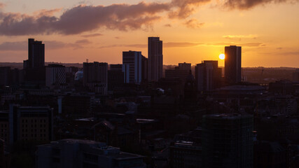 The cityscape of Leeds during the golden hour, showcasing the Building silhouettes against a vibrant sky and the Sunrise, depicting the beauty of this West Yorkshire city