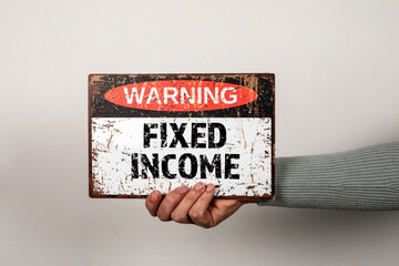 Fixed Income. Warning sign with text in hand - 785722367