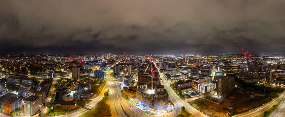 This drone shot spotlights the dazzling city lights of Leeds after sunset, with a focus on West Yorkshire's City Centre and ongoing construction projects