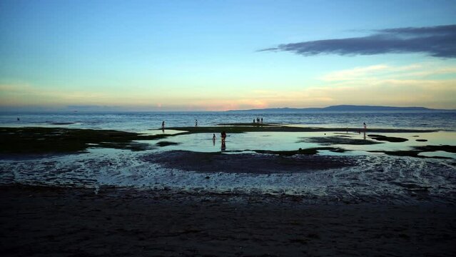 At low tide, people collect algae and mollusks and arthropods, crabs run to the shallows