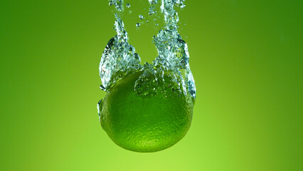 Freeze motion of falling fresh lime fruit into water