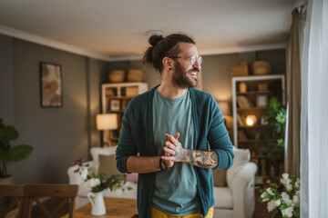 Portrait of adult men with eyeglasses beard and tattoos home happy