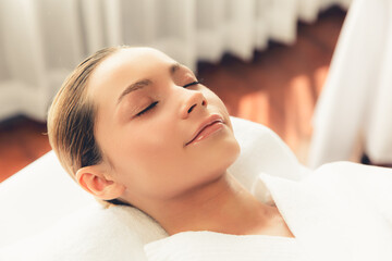Caucasian woman customer enjoying relaxing anti-stress spa massage and pampering with beauty skin recreation leisure in day light ambient salon spa at luxury resort or hotel. Quiescent - obrazy, fototapety, plakaty