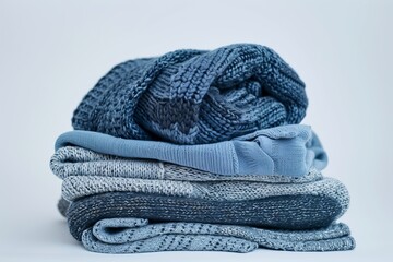 Stack of cozy knitted sweaters in blue
