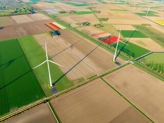 Fields and wind turbines. A wind generator on the  field. View from drone. Green energy production. Landscape from air at the day time. Photo for wallpaper and background. - 785729961