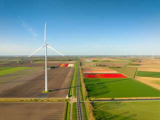 Fields and wind turbines. A wind generator on the  field. View from drone. Green energy production. Landscape from air at the day time. Photo for wallpaper and background.