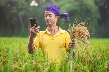 modern indian farmer using mobile phone technology for growth and development