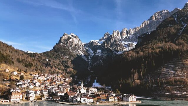 Scenic view of the Alleghe village and Mount Civetta on sunny winter day, Italy