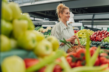 Portrait of a happy woman with basket walking at farmer's market.