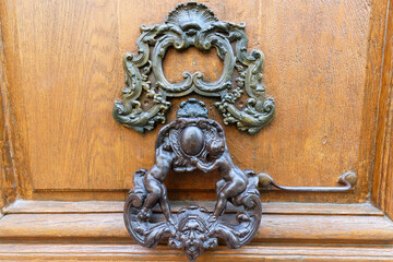 European Vintage old metal wrought iron door knocker. Design detail. Paris.