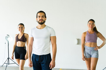 Confident fitness instructors ready for class - 785737353