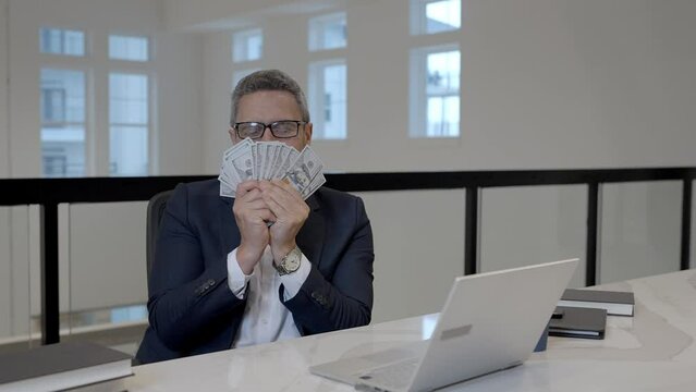 Crazy business man counting money in office. Funny entrepreneur with dollar bills. Excited boss, insurance agent manager. Business freelancer with cash. Fun business owner. Money for business.