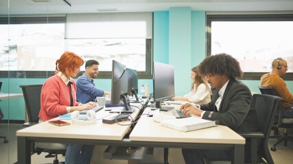 Slow motion video of a multiracial group of office workers enjoying and laughing in the office