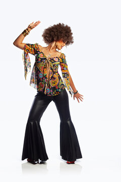 White background studio photo of an ethnic girl disco dancing. 
