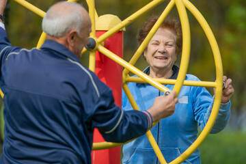 senior couple practicing exercise outdoors - 785744755