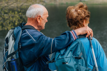 senior couple hiking outdoors in nature - 785744763