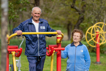 senior couple practicing exercise outdoors - 785744794