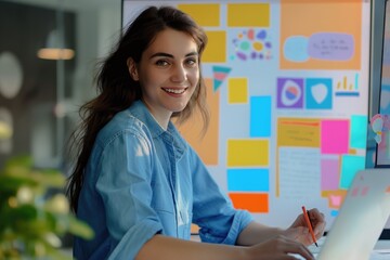 Enthusiastic young woman with glasses drawing on a strategy board filled with colorful notes and diagrams in a bright workspace..