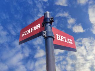 Stress vs Relax. White two street signs with arrow on metal pole with word. Directional road. Crossroads Road Sign, Two Arrow. Blue sky background. Two way road sign with text.