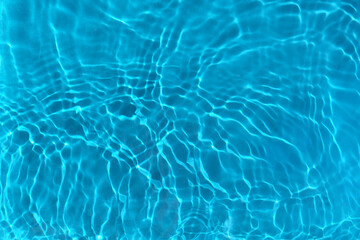 Transparent blue clear water surface texture with ripples, waves and rings in sunlight. Abstract...
