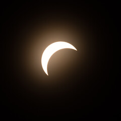 Early stage of the solar eclipse in April 2024 with the moon starting to cover the sun