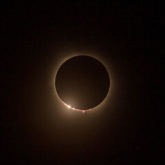 HD images of the solar eclipse in 2024 with the moon finally covering the sun. Baily's beads of light seen through canyons on the moon surface