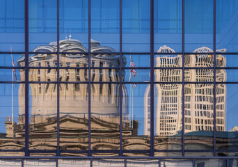 Reflection of the Ohio state Capitol building in the windows of an office building across the...