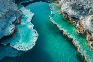 Foto auf Glas Stunning turquoise river gracefully winding through a rocky landscape in a serene natural setting © Larisa AI