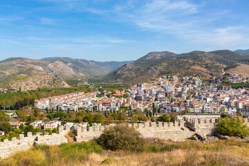 Fototapeta na wymiar Panoramic view of Selcuk town with ancient walls, lush hills, clear skies, travel and culture themes. Selcuk, Izmir, Turkiye (Turkey)