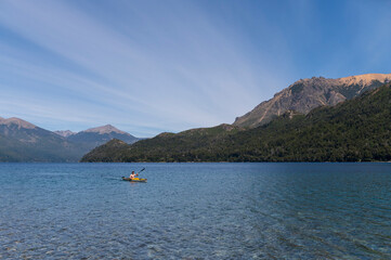 Young teenager practices kayaking and happily enjoys the landscape offered by Argentine Patagonia, Bariloche.