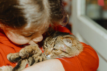 Portrait of a girl with a kitten in her arms.