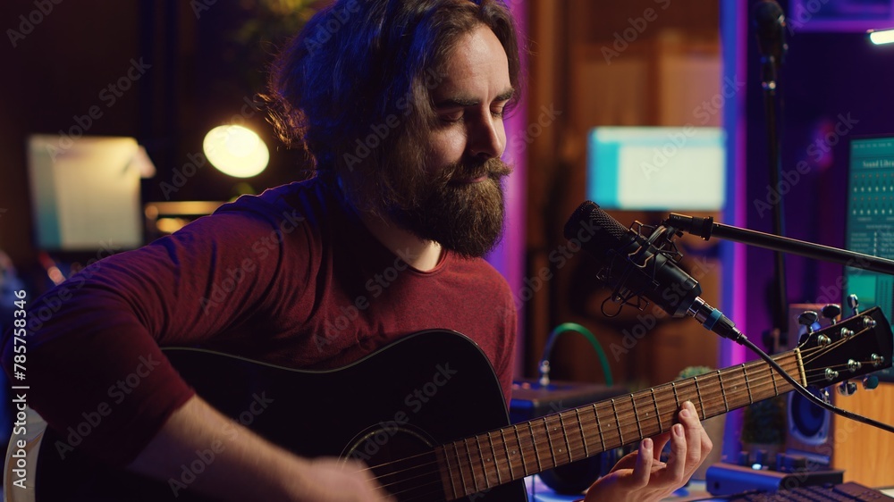 Aufkleber Artist with condenser microphone composing a song on guitar, working on mixing and mastering music. Producer recording tunes and adding sound effects in post production. Camera A.