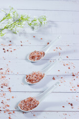 Himalayan pink salt with beneficial properties in ceramic teaspoons.