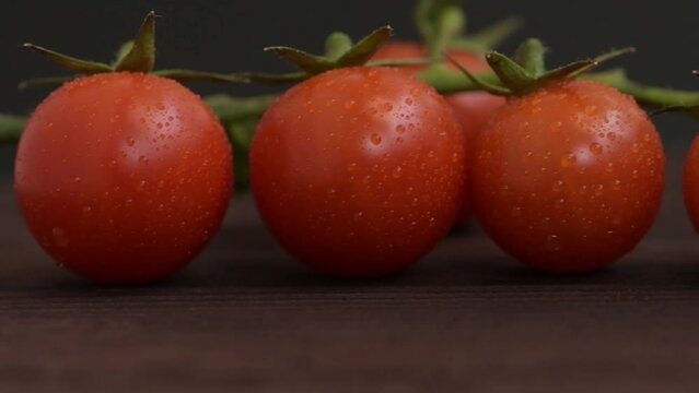 cherry tomatoes with green sprigs on wooden surfac