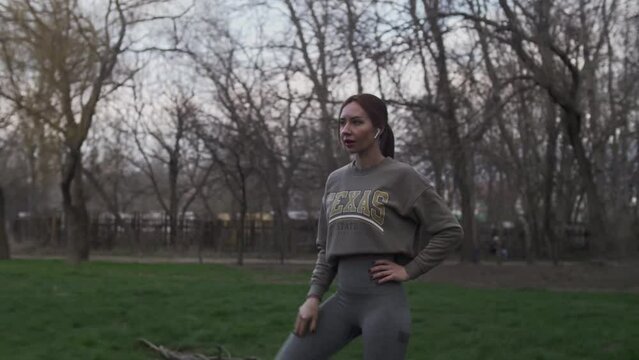 Girl in sportswear doing physical exercises 