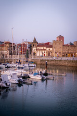 Calm evening, Gij&oacute;n harbor, purple twilight, cityscape, serene sea, tranquil atmosphere.