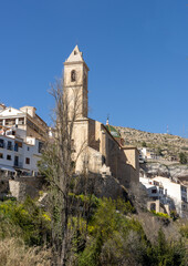 Fototapeta na wymiar Alcalá del Júcar, is located on a rock formed by the gorge of the Júcar River, cave houses roman bridge, castle, Church of San Andrés Apóstol (Albacete, Spain).