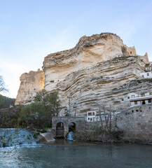 Alcalá del Júcar, is located on a rock formed by the gorge of the Júcar River, cave houses roman bridge, castle, Church of San Andrés Apóstol (Albacete, Spain).