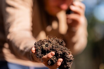 university student conducting research on forest health. farmer collecting soil samples in a test...