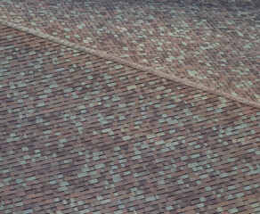 Abstract Aerial Closeup of an Arched Roof with Tan and Brown Shingles.